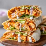 Homemade Buffalo Chicken Wraps filled with shredded chicken, lettuce, celery, and a drizzle of ranch dressing.