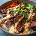 Homemade Korean BBQ Steak Bowls with sliced grilled steak, rice, spicy mayo, scallions, carrots, and greens.