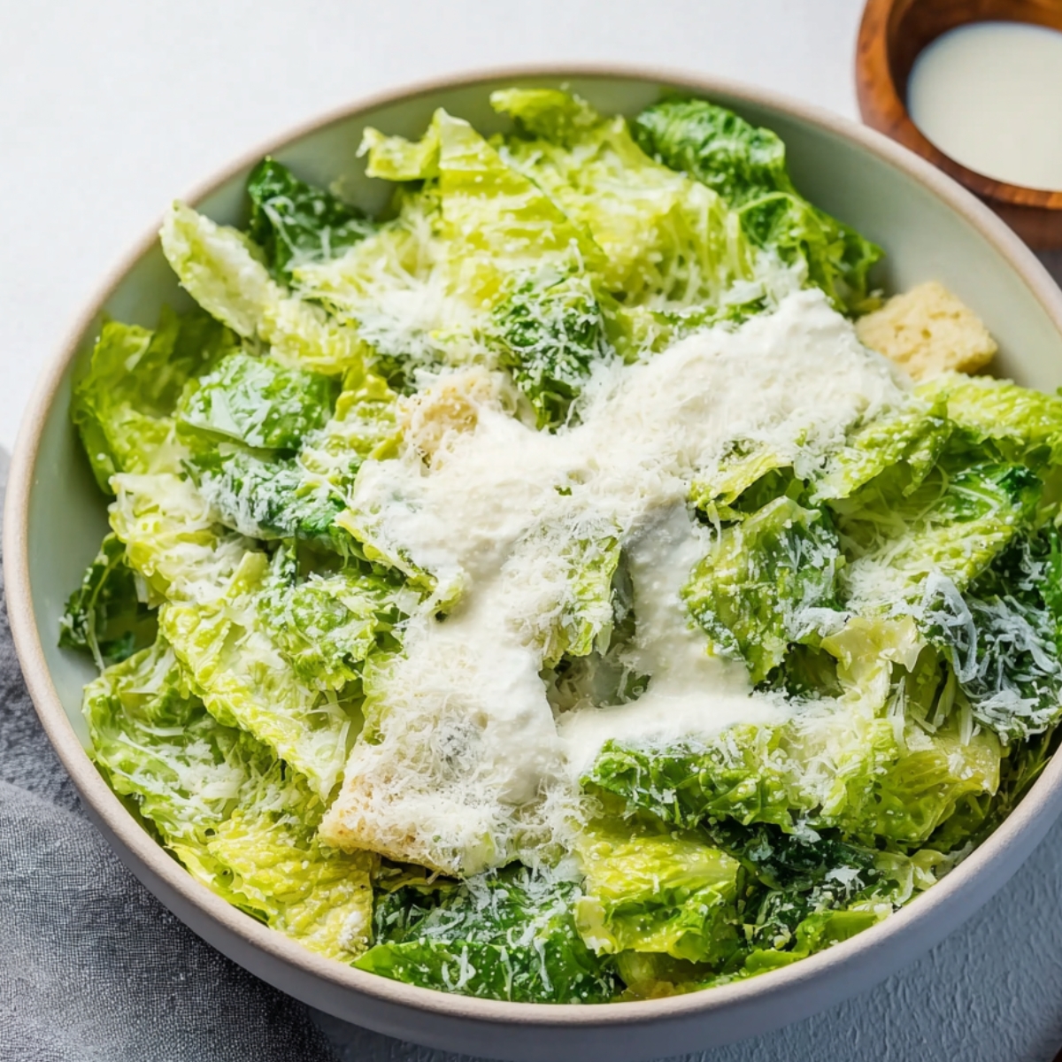 Toss the chopped Romaine with the remaining Parmesan and enough lemon dressing to coat everything nicely.