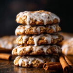 Stack of Iced Gingerbread Oatmeal Cookies drizzled with cinnamon glaze and sprinkled with spice.